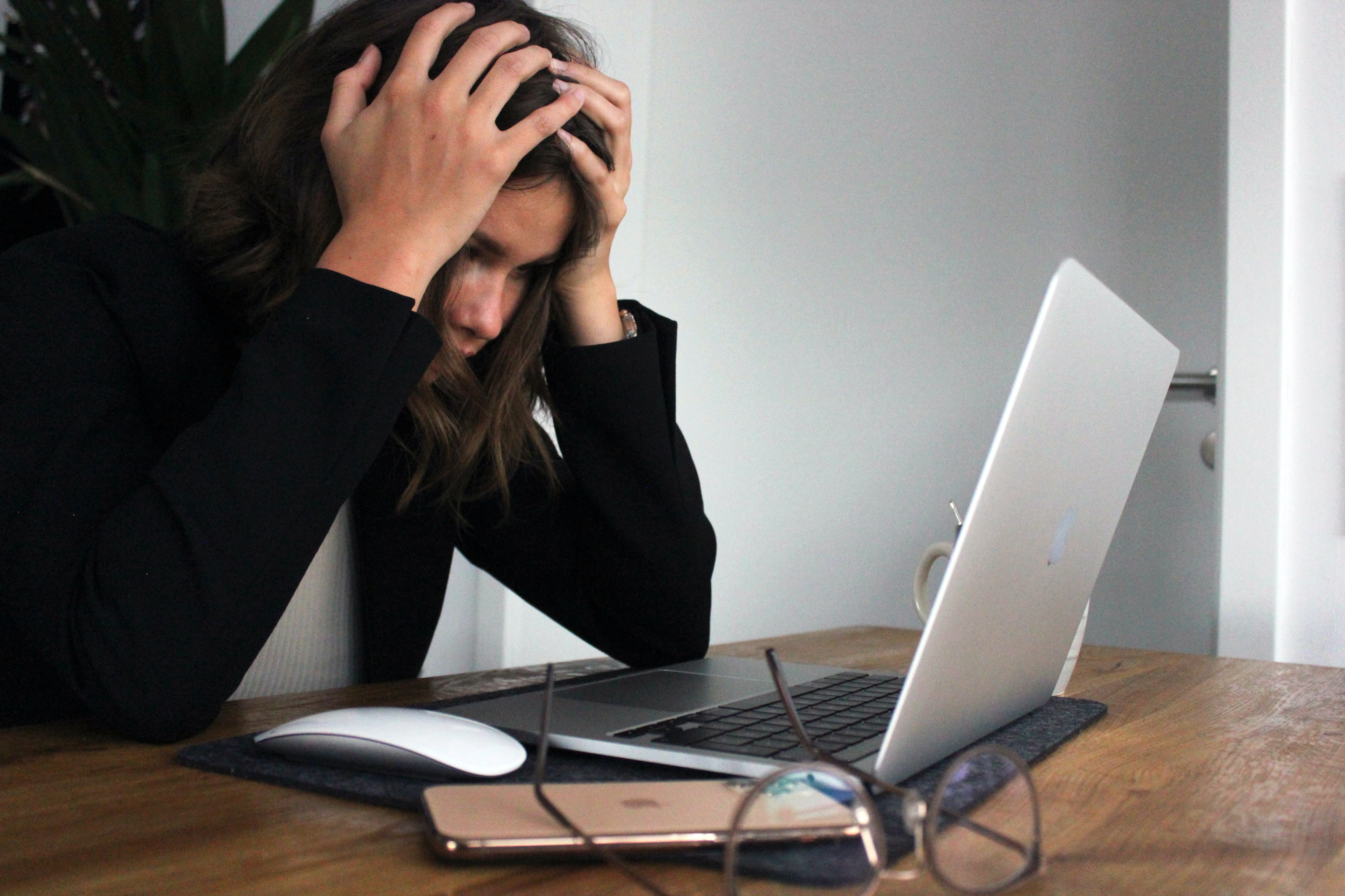 Woman burnt out in front of her laptop